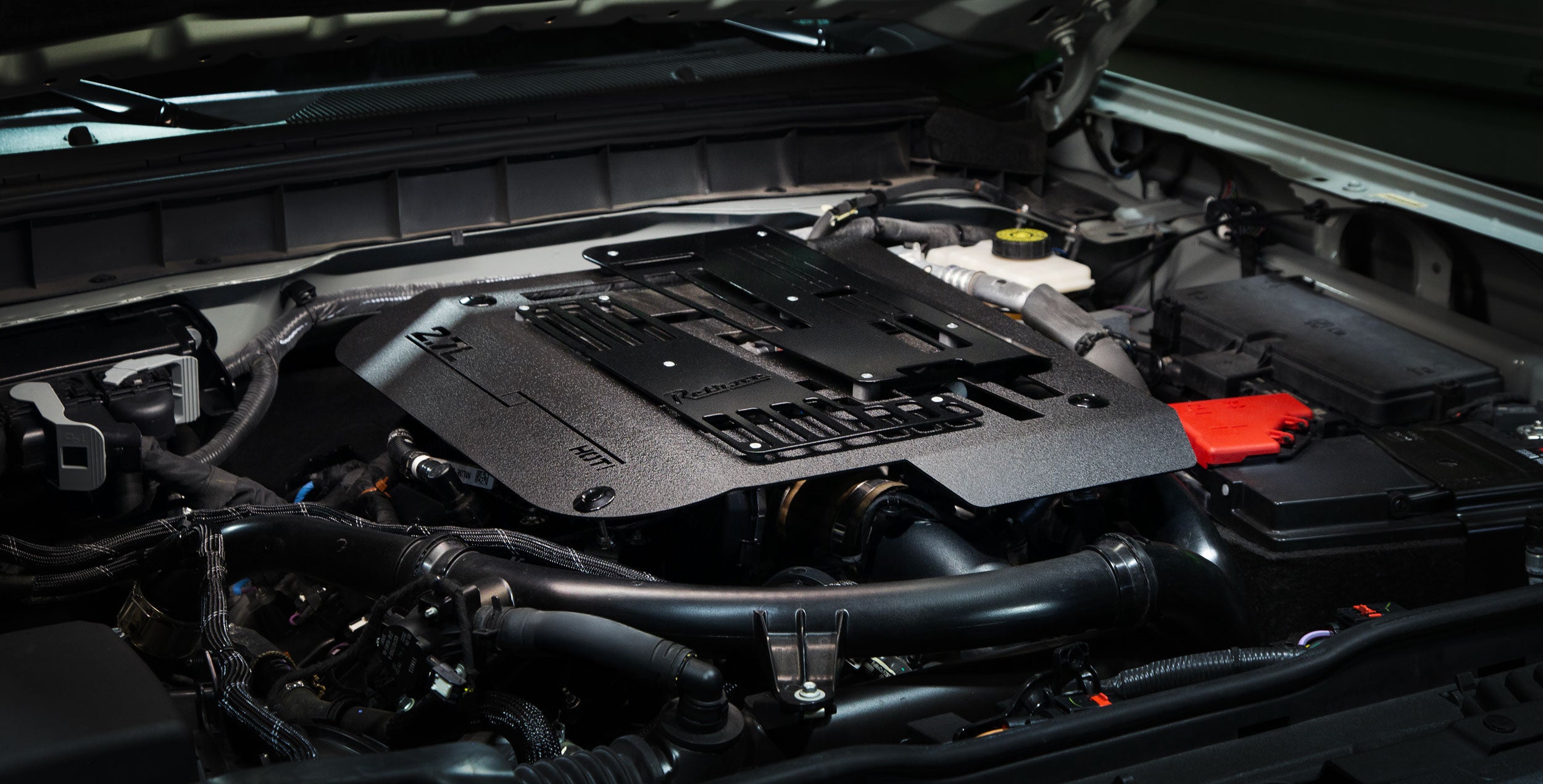 Retrove toolless quick release aluminum engine cover installed on a 2.7L Ford Bronco.
